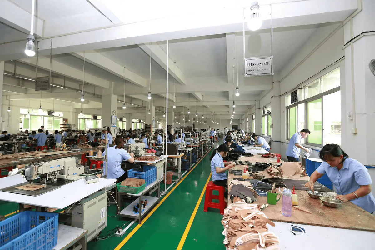 Ballman factory interior workshop, skilled workers manufacturing genuine leather bags and wallets, leather goods production capacity introduction